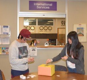  Two international students Aaron Khaw of Malaysia, a cell and molecular biology major, and has been at WSU for two years; and Wee Leen Chin of Malaysia, an advertising major, and has been at WSU for one year, prepared for a club event in the international services office on Monday.