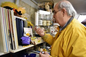 Hunt looks through items in the corner of his shop that is made up of strictly Winona memorabilia.