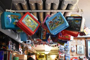 Old lunchboxes hang from ceiling pipes in Hunt’s antique shop.