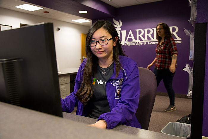 Senior Rachel OuYong sits at her computer desk in Technical Support in Somsen Hall at Winona State and waits to help students with their malfunctioning devices on Monday, April 24, 2017.