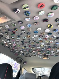 A car ceiling full of collector buttons